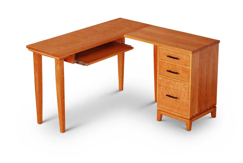 Corner Desk in cherry with drawer pedestal on right containing two drawers and one file cabinet, keyboard shelf on left