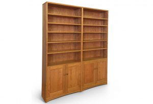 Double bookcase in cherry, each side has lower cabinet doors and six shelves on top