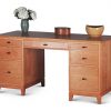 Double Pedestal Desk in Cherry with two drawers and file drawer on left, center drawer, two drawers and file drawer on right, all with black knobs