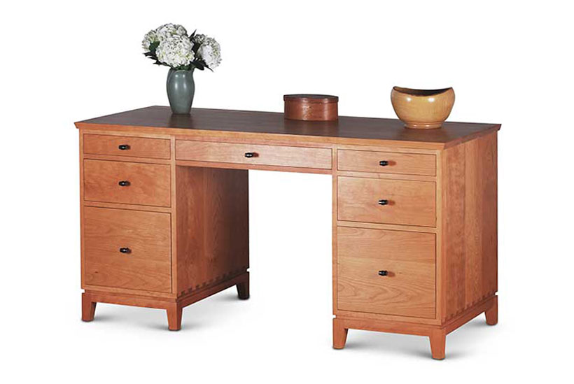 Double Pedestal Desk in Cherry with two drawers and file drawer on left, center drawer, two drawers and file drawer on right, all with black knobs